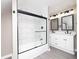 Well-lit bathroom showcasing a glass-enclosed tub/shower and a stylish vanity area with sink at 1921 N Dexter St, Indianapolis, IN 46202
