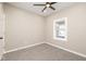 A serene bedroom featuring neutral walls, carpet, a ceiling fan, and a sun-filled window at 1921 N Dexter St, Indianapolis, IN 46202