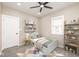A bedroom with toys, shelving, carpeting, and abundant natural light from the window at 1921 N Dexter St, Indianapolis, IN 46202
