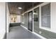 View of the spacious front porch with new lighting fixture and a new black screen door at 1921 N Dexter St, Indianapolis, IN 46202