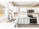 Bright kitchen with white countertops and cabinetry, stainless steel appliances, and a stylish faucet at 1921 N Dexter St, Indianapolis, IN 46202