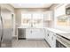 Bright kitchen featuring stainless steel appliances, modern faucet, and stylish cabinetry at 1921 N Dexter St, Indianapolis, IN 46202
