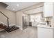 Open-concept design with stairs, living room, and modern stainless steel refrigerator enhance this home's appeal at 1921 N Dexter St, Indianapolis, IN 46202