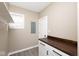 This laundry room features white cabinets, a butcher block countertop, and a bright window at 1921 N Dexter St, Indianapolis, IN 46202
