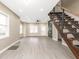 Bright living room with wood-look flooring, fireplace, and modern staircase at 1921 N Dexter St, Indianapolis, IN 46202