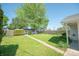 Backyard featuring a mature tree, one car detached garage and carport at 1932 Central Ave, Columbus, IN 47201