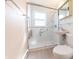 A bathroom with a new glass shower door, subway tile, and accessibility handrailings at 1932 Central Ave, Columbus, IN 47201
