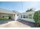 Exterior backyard view featuring a covered carport and sunroom at 1932 Central Ave, Columbus, IN 47201