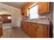 View of kitchen area featuring classic wooden cabinets and ample counter space at 1932 Central Ave, Columbus, IN 47201