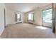 Spacious living room with natural light, neutral carpet, and access to the outdoors at 1932 Central Ave, Columbus, IN 47201