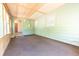Enclosed porch or sunroom with carpet flooring, pastel walls, and lots of light at 1932 Central Ave, Columbus, IN 47201