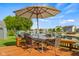 Enjoy this beautiful backyard deck with waterfront views, table seating, and a lovely umbrella at 1969 Westminster Pl, Columbus, IN 47201