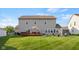This home features a large green backyard with a deck and waterfront views at 1969 Westminster Pl, Columbus, IN 47201