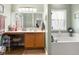 Bathroom featuring a vanity with sink and a soaking tub under a window at 1969 Westminster Pl, Columbus, IN 47201