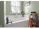 Bright bathroom with a white soaking tub under a window, offering a serene space at 1969 Westminster Pl, Columbus, IN 47201
