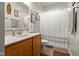 Well-maintained bathroom with a single sink vanity and white shower curtain at 1969 Westminster Pl, Columbus, IN 47201
