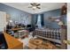 Cozy bedroom featuring blue walls, a ceiling fan, and pop culture decorations at 1969 Westminster Pl, Columbus, IN 47201