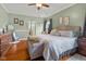 Spacious bedroom featuring wood floors, a ceiling fan, and decoratively painted walls at 1969 Westminster Pl, Columbus, IN 47201