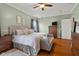 Comfortable bedroom with wood floors, ceiling fan, bench and upholstered headboard at 1969 Westminster Pl, Columbus, IN 47201