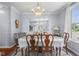 Bright dining room showcases a chandelier, mirror wall, and traditional wood furniture at 1969 Westminster Pl, Columbus, IN 47201