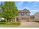 Charming two-story home with brick accents, tidy landscaping, and an attached two-car garage at 1969 Westminster Pl, Columbus, IN 47201