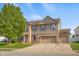 Charming two-story home with brick accents, tidy landscaping, and an attached two-car garage at 1969 Westminster Pl, Columbus, IN 47201