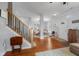 Inviting foyer features hardwood floors, open staircase, and seamless transition to the dining area at 1969 Westminster Pl, Columbus, IN 47201
