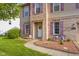 Inviting home entrance features a classic white door, brick accents, and colorful landscaping at 1969 Westminster Pl, Columbus, IN 47201