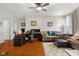 Comfortable living room with a ceiling fan, hardwood floors, and lots of natural light at 1969 Westminster Pl, Columbus, IN 47201