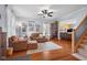 Cozy living room features a ceiling fan, wood floors, and comfortable seating arrangement at 1969 Westminster Pl, Columbus, IN 47201