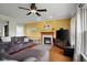Inviting living room with a cozy fireplace, plush sofa, and ceiling fan at 1969 Westminster Pl, Columbus, IN 47201