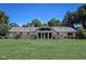 Expansive backyard featuring an A-frame glass wall with sliding doors and a large well-kept lawn, great for entertaining at 2204 Center Dr, Lebanon, IN 46052