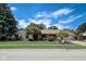 Charming ranch home featuring a manicured lawn, mature trees, and brick facade, set under a bright blue sky at 2204 Center Dr, Lebanon, IN 46052
