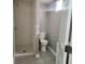 Bathroom featuring a tiled shower and a toilet at 2324 E 36Th St, Indianapolis, IN 46218