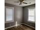 Cozy bedroom featuring laminated floors, neutral paint, and two bright windows at 2324 E 36Th St, Indianapolis, IN 46218