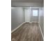 Bedroom featuring wood-look flooring, a window, and white trim at 2324 E 36Th St, Indianapolis, IN 46218
