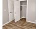 Bedroom featuring wood-look flooring and closet with white doors at 2324 E 36Th St, Indianapolis, IN 46218