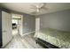 A bedroom with light wood floors with a ceiling fan at 2324 E 36Th St, Indianapolis, IN 46218