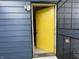 Close-up of the bright yellow door with storm door at 2324 E 36Th St, Indianapolis, IN 46218