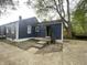 Rear exterior of the home with blue siding and a large backyard at 2324 E 36Th St, Indianapolis, IN 46218