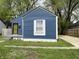Quaint blue home featuring a large window and a freshly painted exterior at 2324 E 36Th St, Indianapolis, IN 46218