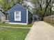 Blue house with a long driveway leading to a matching garage in the back at 2324 E 36Th St, Indianapolis, IN 46218