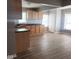 Open-concept kitchen featuring wooden cabinets, dark countertops, and laminate flooring at 2324 E 36Th St, Indianapolis, IN 46218