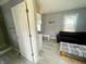 Open living area with couch, table, and small kitchen area at 2324 E 36Th St, Indianapolis, IN 46218
