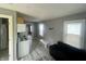 View of the open floor plan with couch, table, small kitchen area, and view to another room at 2324 E 36Th St, Indianapolis, IN 46218