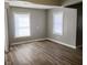 Neutral living area with laminate flooring, white trim, and bright windows at 2324 E 36Th St, Indianapolis, IN 46218