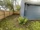 Side yard view with grassy lawn and partial view of the fence and exterior of a home at 2324 E 36Th St, Indianapolis, IN 46218