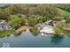 Aerial view showcasing lakeside homes, sandy beach, community pool, and lush greenery at 2829 Somerset Bay, Indianapolis, IN 46240