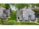 Charming grey two-story home with lush green lawn and serene lake view provides an inviting retreat at 2829 Somerset Bay, Indianapolis, IN 46240