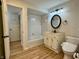Modern bathroom with a shower-tub, vanity, and toilet, with hardwood floors and a clean, bright aesthetic at 2829 Somerset Bay, Indianapolis, IN 46240